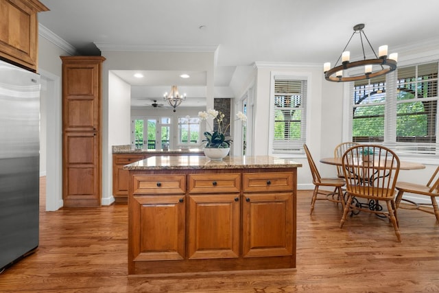 410C Highlands Cove Dr Unit 1300C, Highlands, NC 28741 - kitchen featuring a chandelier, stainless steel refrigerator, light wood finished floors, brown cabinets, and crown molding