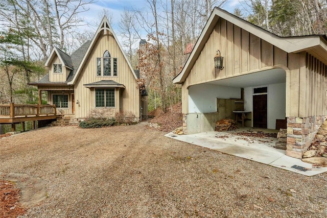 back of property with roof with shingles and board and batten siding