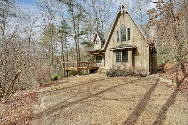 exterior space featuring metal roof, a deck, and board and batten siding