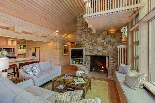 49 Hickory Ln, Highlands, NC 28741 - living room with wood finished floors, wood ceiling, wood walls, a stone fireplace, and high vaulted ceiling