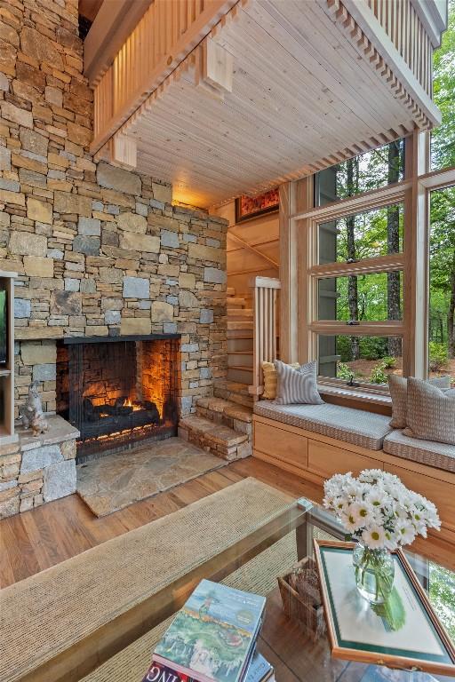 49 Hickory Ln, Highlands, NC 28741 - living room with a stone fireplace, wood finished floors, wood ceiling, and wooden walls