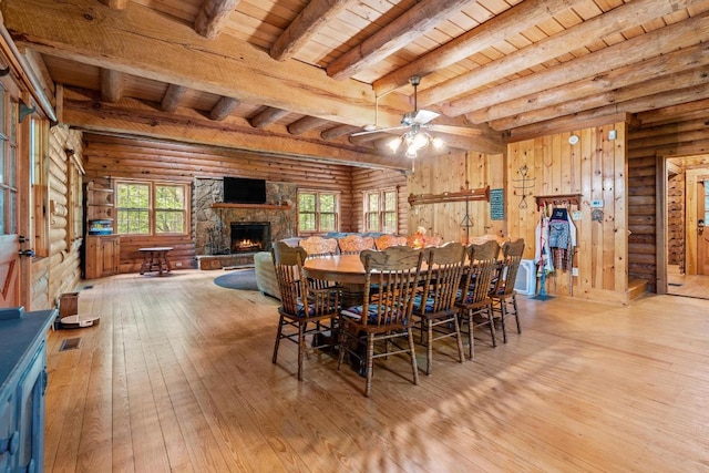 130 Sarah Cove Rd, Otto, NC 28763 - dining room featuring log walls, wood ceiling with exposed beams, hardwood / wood-style flooring, plenty of natural light, and a fireplace