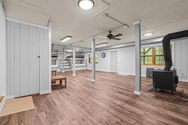 130 Sarah Cove Rd, Otto, NC 28763 - basement featuring a wood stove, wood finished floors, stairway, and plenty of natural light