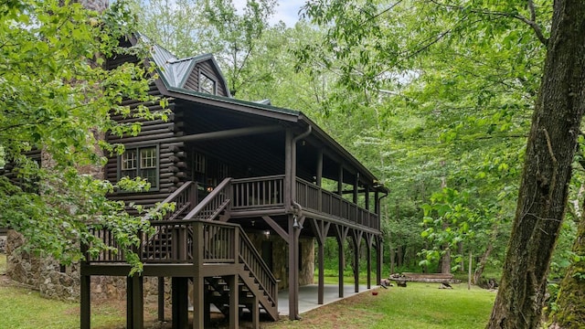 130 Sarah Cove Rd, Otto, NC 28763 - view of front facade with log exterior, stairway, a patio area, a wooden deck, and a front yard