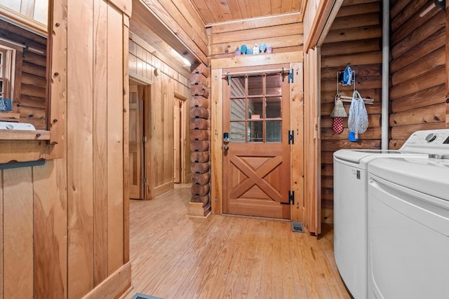 130 Sarah Cove Rd, Otto, NC 28763 - laundry area featuring washing machine and clothes dryer, light wood-style flooring, log walls, and wooden ceiling