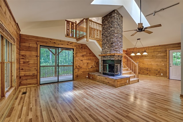 142 Golden Mist Ct, Sapphire, NC 28774 - unfurnished living room featuring wooden walls, stairway, high vaulted ceiling, light wood finished floors, and a ceiling fan