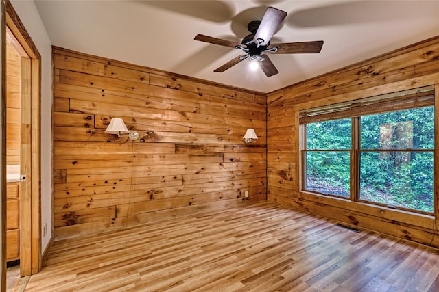 142 Golden Mist Ct, Sapphire, NC 28774 - empty room featuring ceiling fan, light wood finished floors, and wooden walls