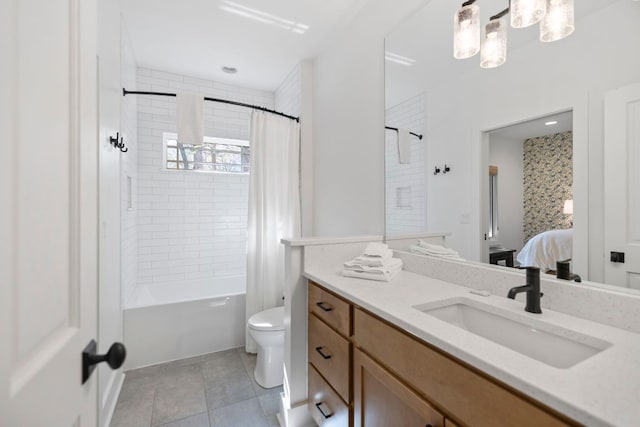 ensuite bathroom with tile patterned flooring, vanity, toilet, shower / bath combo with shower curtain, and ensuite bathroom
