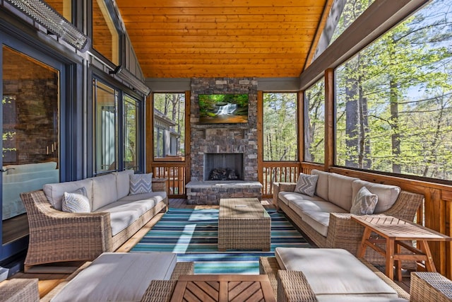 sunroom / solarium featuring an outdoor living space with a fireplace