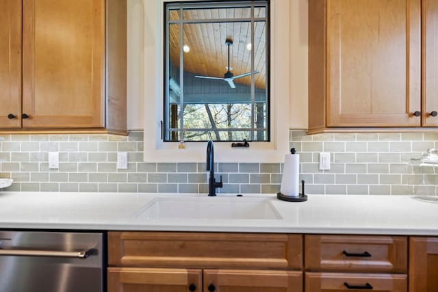 kitchen with stainless steel dishwasher, a sink, and backsplash