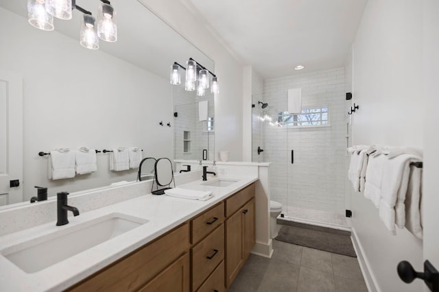bathroom featuring a sink, tile patterned flooring, and a shower stall