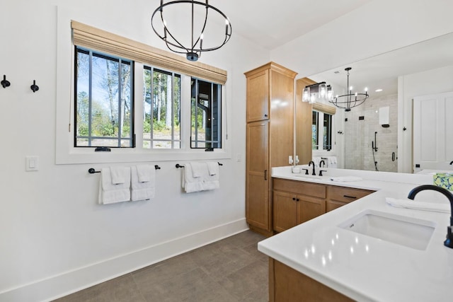 full bathroom with a chandelier, plenty of natural light, a sink, and a stall shower
