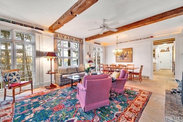 living area with beamed ceiling and ceiling fan with notable chandelier