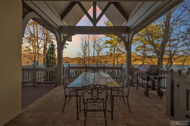 patio terrace at dusk featuring a gazebo and grilling area