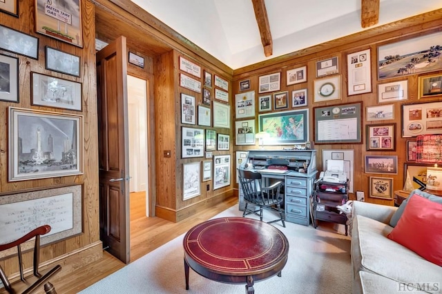 home office featuring light wood-type flooring and beamed ceiling