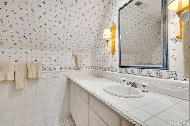 bathroom with tile walls and vanity