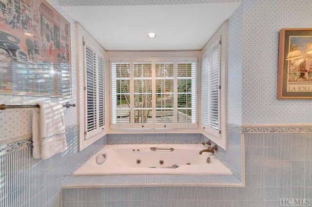 bathroom featuring tile walls and tiled bath