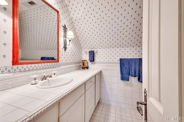 bathroom featuring tile walls, vanity, and tile patterned flooring