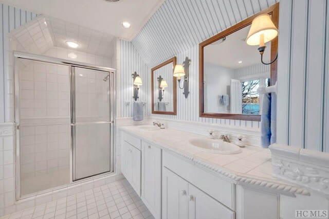 bathroom featuring tile patterned flooring, vanity, and a shower with shower door