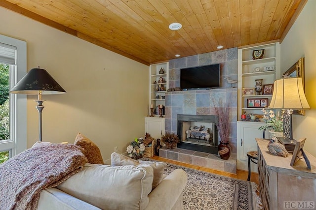 living room featuring wood ceiling, a fireplace, built in features, and hardwood / wood-style flooring