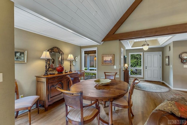 dining space featuring wood ceiling, lofted ceiling, and light hardwood / wood-style floors