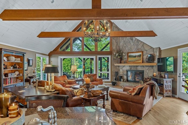 living room with high vaulted ceiling, a notable chandelier, beamed ceiling, a fireplace, and light hardwood / wood-style floors