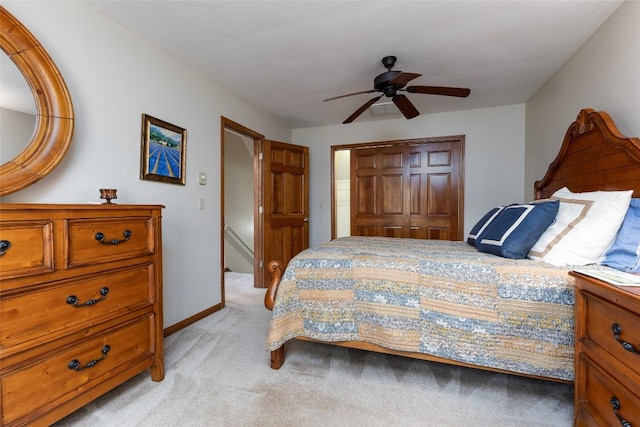 1964 Woods Mountain Trl, Cullowhee, NC 28723 - bedroom with light carpet, a closet, ceiling fan, and baseboards