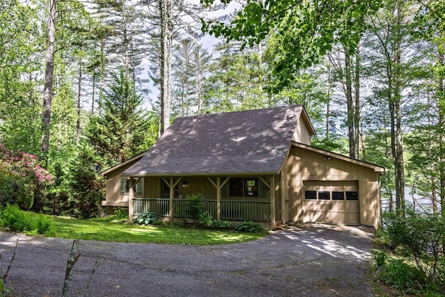 1964 Woods Mountain Trl, Cullowhee, NC 28723 - view of front facade with an attached garage, driveway, covered porch, and roof with shingles