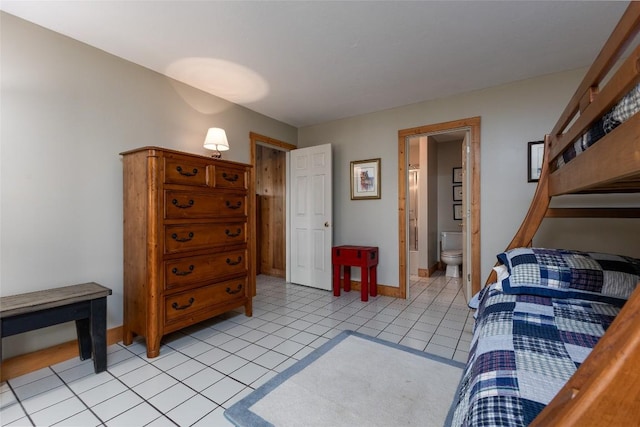 1964 Woods Mountain Trl, Cullowhee, NC 28723 - bedroom featuring baseboards, light tile patterned floors, and connected bathroom