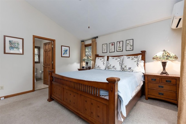 1964 Woods Mountain Trl, Cullowhee, NC 28723 - bedroom featuring light carpet, a wall mounted air conditioner, lofted ceiling, ensuite bath, and baseboards