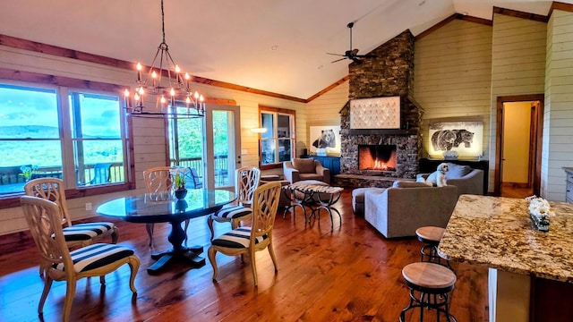 71 Raptor Way, Sapphire, NC 28774 - dining area with wood walls, hardwood / wood-style floors, a fireplace, a chandelier, and high vaulted ceiling