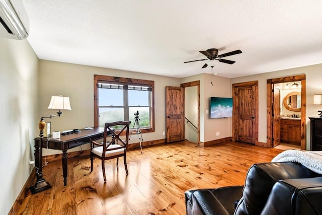 71 Raptor Way, Sapphire, NC 28774 - home office featuring a wall mounted AC, light wood-style flooring, and ceiling fan