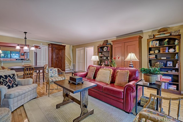 living room with light hardwood / wood-style floors and crown molding