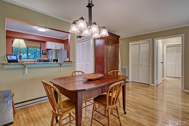 dining space featuring ornamental molding, a notable chandelier, light hardwood / wood-style floors, and baseboard heating