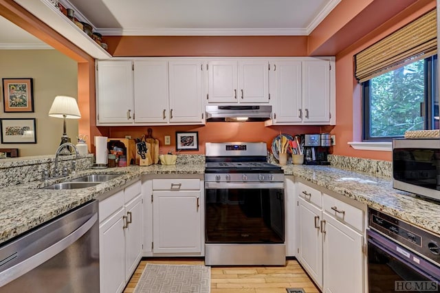 kitchen with sink, crown molding, stainless steel appliances, white cabinets, and light stone countertops