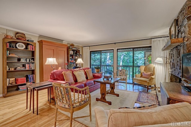 living room with light hardwood / wood-style flooring and crown molding