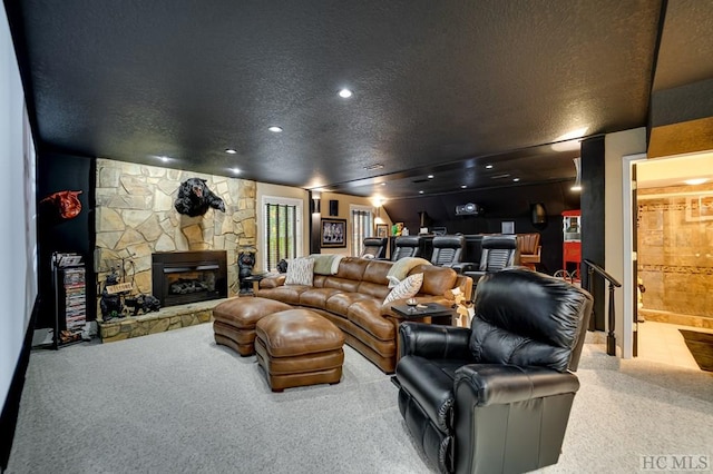 carpeted living room featuring a stone fireplace and a textured ceiling