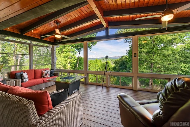 sunroom with ceiling fan, wood ceiling, and lofted ceiling with beams