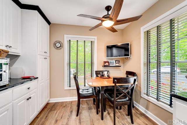 dining room with light hardwood / wood-style floors and ceiling fan