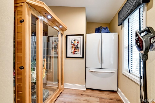 kitchen with white fridge and light hardwood / wood-style floors