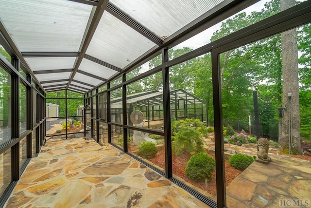 unfurnished sunroom with vaulted ceiling