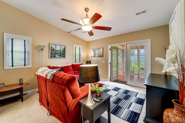 carpeted living room with lofted ceiling, ceiling fan, and plenty of natural light