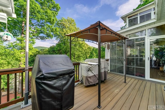 wooden deck featuring area for grilling