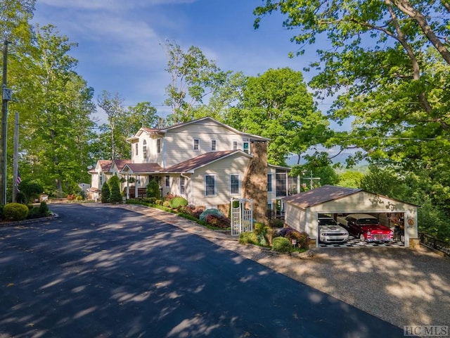 view of front facade featuring a garage and an outbuilding