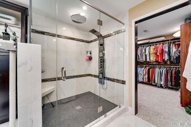 bathroom featuring a shower with shower door