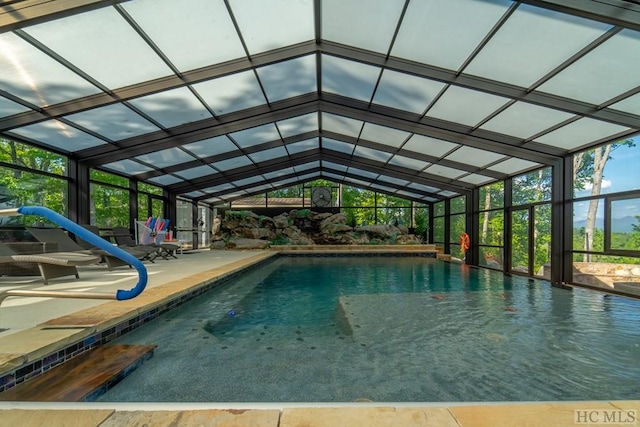 view of swimming pool with a patio and glass enclosure