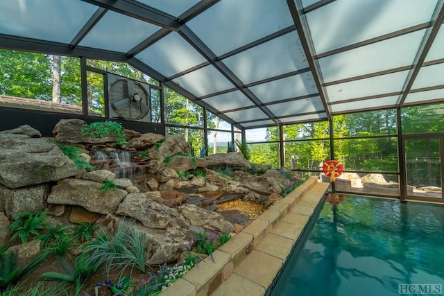 view of pool featuring glass enclosure