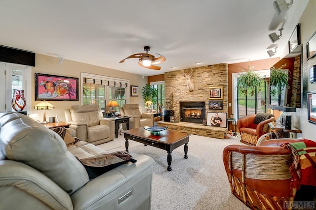 living room with a fireplace, carpet, and ceiling fan