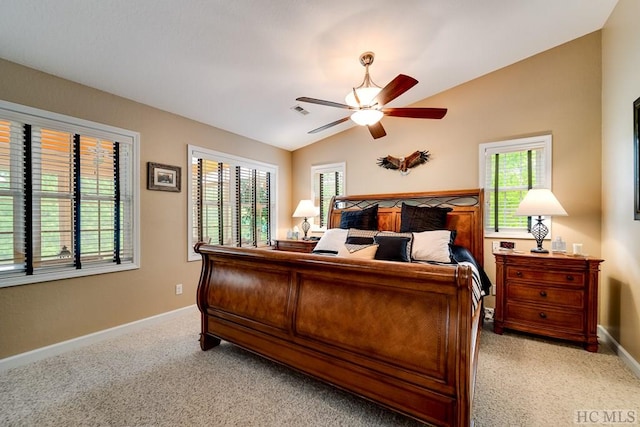 bedroom featuring light carpet, vaulted ceiling, and ceiling fan