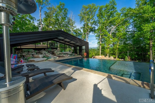 view of swimming pool featuring a patio area